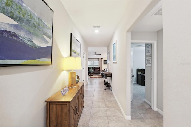 hall featuring light tile patterned floors