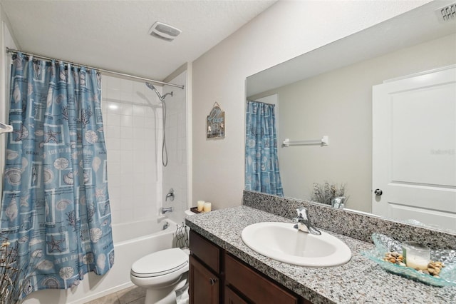 full bathroom with shower / tub combo, tile patterned floors, a textured ceiling, toilet, and vanity