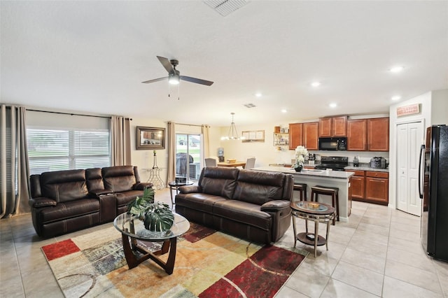 tiled living room with ceiling fan