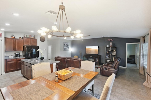 dining area with sink, an inviting chandelier, and light tile patterned flooring