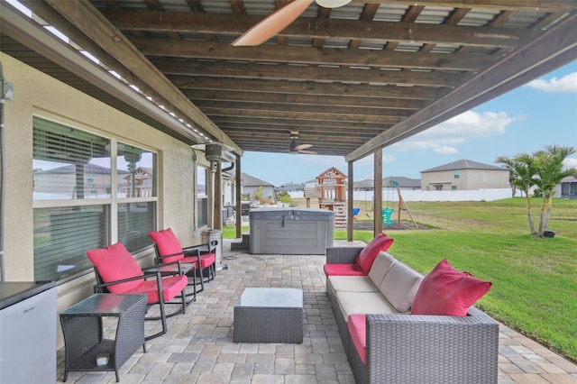 view of patio / terrace featuring a playground, an outdoor hangout area, and a hot tub