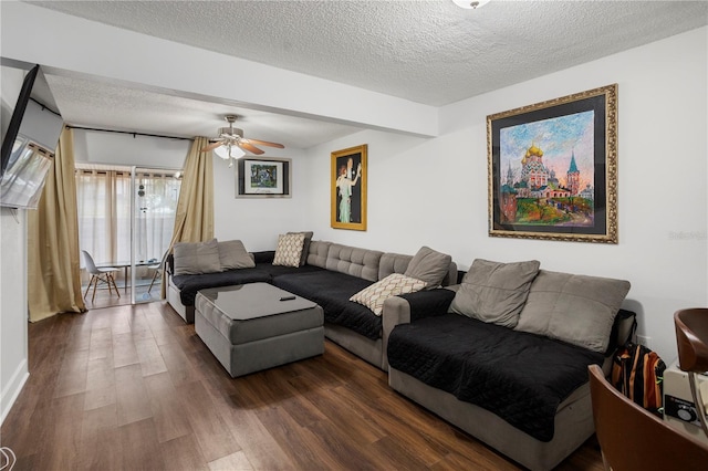 living room with ceiling fan, dark hardwood / wood-style floors, and a textured ceiling