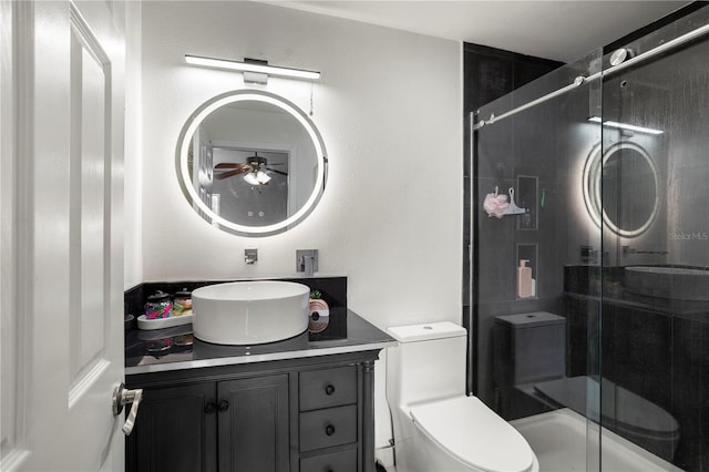 bathroom featuring toilet, ceiling fan, walk in shower, and vanity