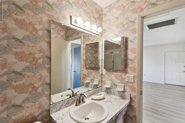 bathroom featuring vanity and wood-type flooring