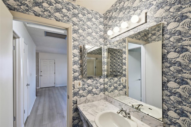 bathroom with vanity and wood-type flooring