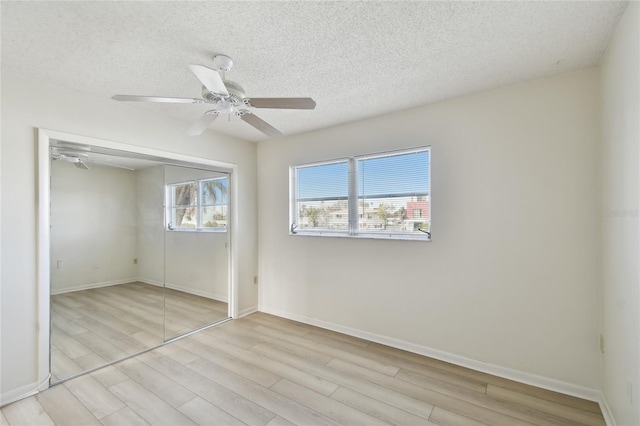 unfurnished bedroom featuring a closet, ceiling fan, and a textured ceiling