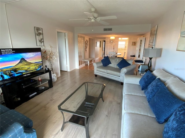 living room with hardwood / wood-style floors and ceiling fan