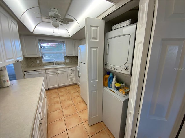 laundry area with ceiling fan, sink, stacked washer / drying machine, and light tile patterned flooring