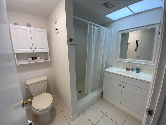 bathroom with vanity, a skylight, walk in shower, and toilet