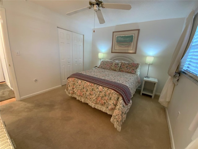 carpeted bedroom with ceiling fan and a closet