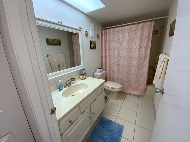 full bathroom with tile patterned flooring, vanity, a skylight, toilet, and shower / bath combo