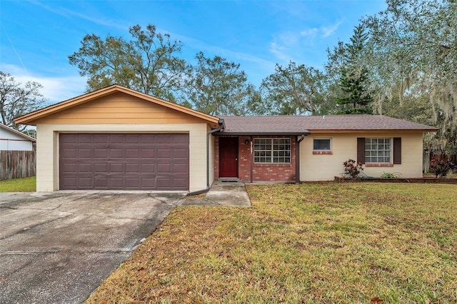 single story home featuring a garage and a front yard