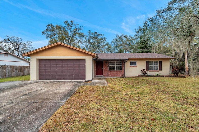 single story home featuring a garage and a front lawn