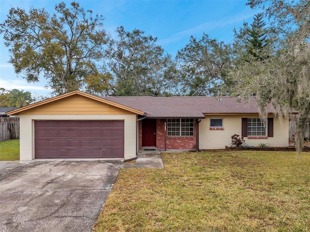 ranch-style home with a garage and a front lawn