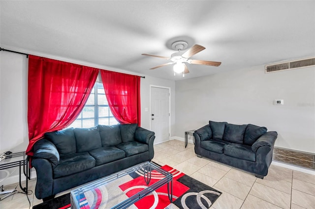 tiled living room with ceiling fan and a textured ceiling