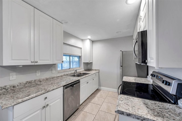 kitchen with sink, light tile patterned floors, stainless steel appliances, and white cabinets