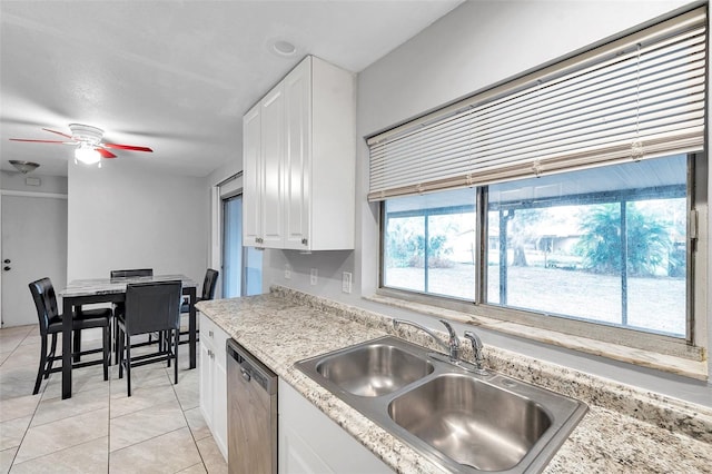 kitchen with sink, white cabinetry, light tile patterned floors, dishwasher, and ceiling fan