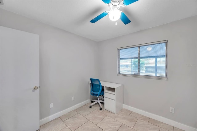 unfurnished office with ceiling fan and light tile patterned floors