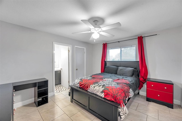 bedroom featuring light tile patterned flooring, ceiling fan, ensuite bathroom, and a textured ceiling