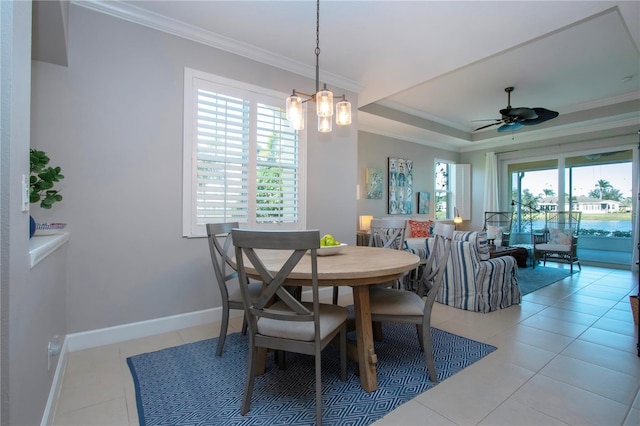 dining area featuring light tile patterned floors, ceiling fan with notable chandelier, plenty of natural light, and ornamental molding