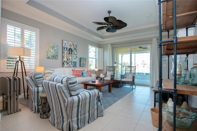 living room with plenty of natural light, a raised ceiling, and light tile patterned flooring