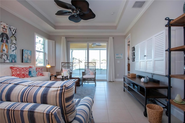 bedroom featuring ceiling fan, access to exterior, a raised ceiling, and multiple windows