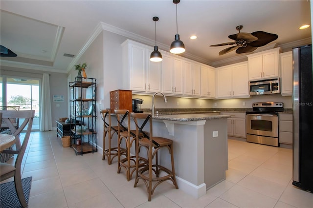 kitchen with light tile patterned flooring, white cabinetry, ornamental molding, stone counters, and stainless steel appliances