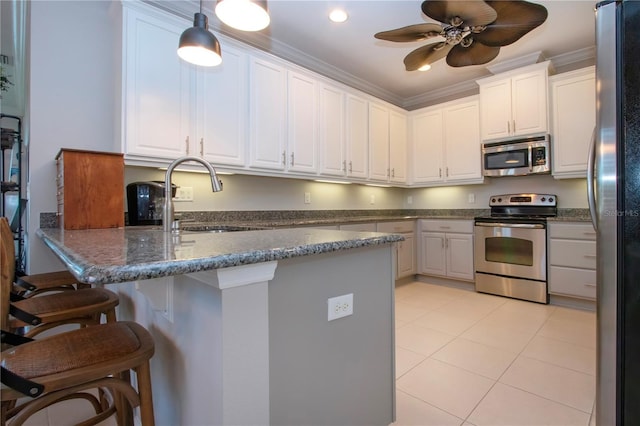 kitchen featuring white cabinetry, sink, ornamental molding, and appliances with stainless steel finishes