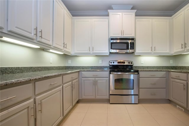 kitchen featuring white cabinetry, ornamental molding, and appliances with stainless steel finishes