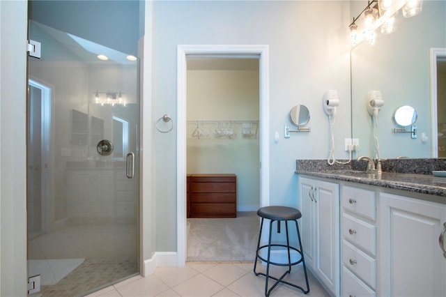 bathroom featuring an enclosed shower, vanity, and tile patterned floors