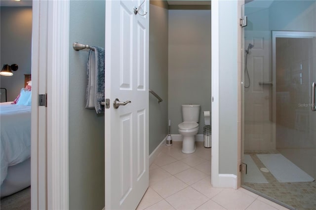 bathroom featuring walk in shower, tile patterned floors, and toilet