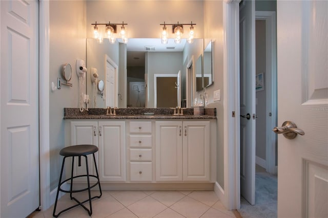 bathroom featuring tile patterned flooring and vanity