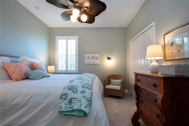 carpeted bedroom with ceiling fan and a closet