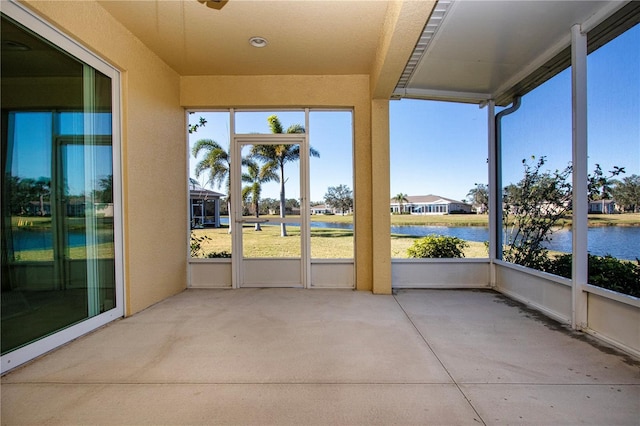 unfurnished sunroom with a water view