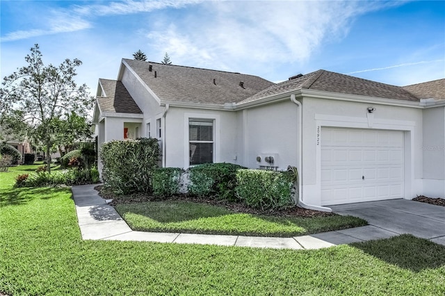 ranch-style house featuring a front yard and a garage