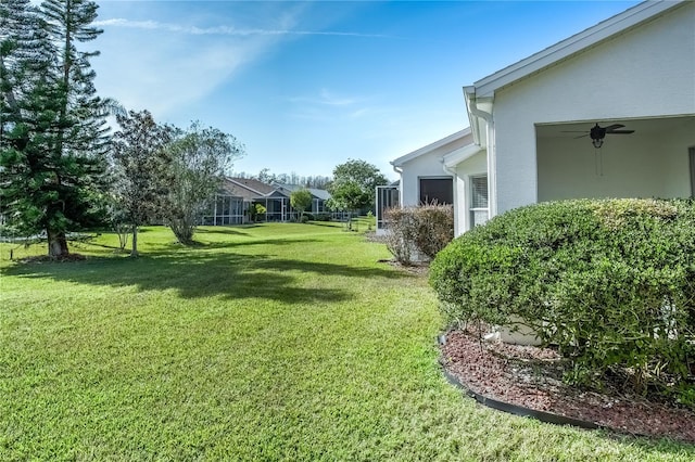 view of yard featuring ceiling fan