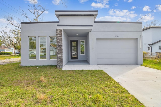 view of front facade with a front yard and a garage