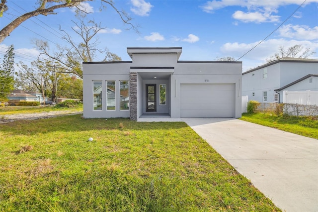 view of front of home with a front yard and a garage