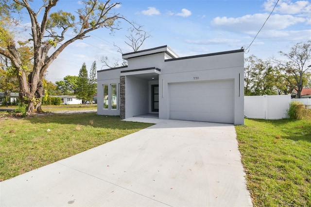 contemporary house with a front lawn and a garage