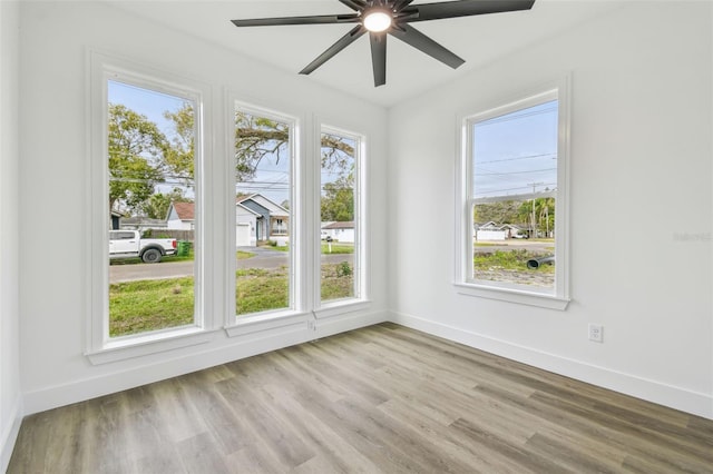 empty room with light wood-type flooring and ceiling fan