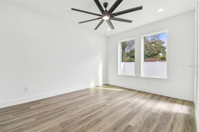 spare room with ceiling fan and light hardwood / wood-style flooring