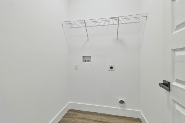 clothes washing area with wood-type flooring, hookup for a washing machine, and hookup for an electric dryer