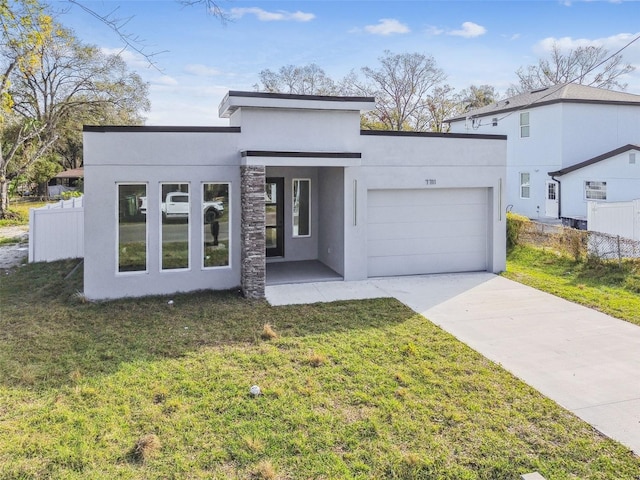 view of front of property with a garage and a front yard