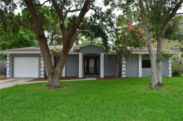 ranch-style home featuring a garage and a front lawn