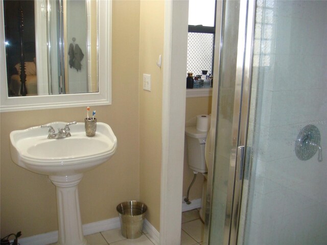 bathroom featuring an enclosed shower and tile patterned floors