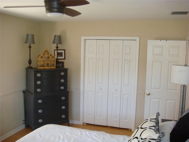 bedroom with ceiling fan and a closet