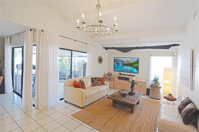 living room featuring a notable chandelier, beam ceiling, and light tile patterned flooring