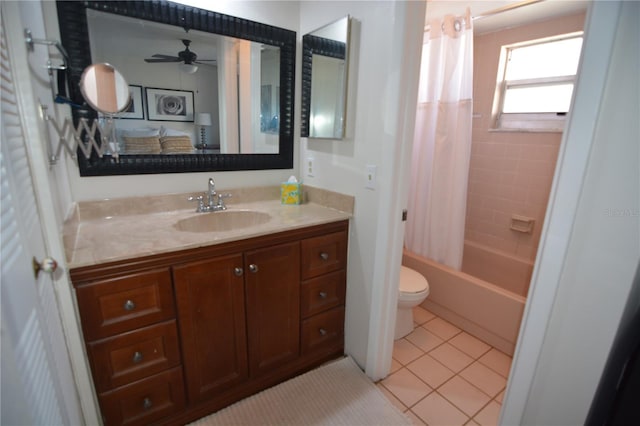 full bathroom with ceiling fan, vanity, tile patterned floors, toilet, and shower / bath combo with shower curtain