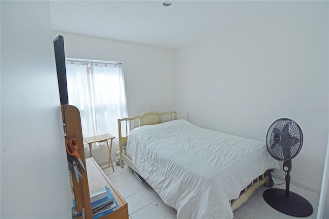 tiled bedroom with a textured ceiling