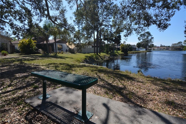 view of home's community featuring a water view and a yard